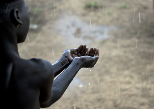 Kid From Karo Tribe Having A Shower Under The Rain, Korcho Village, Omo Valley, Ethiopia