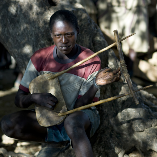 Portrait Of A Konso Tribe Musician Playing Krar, A Self Made Harp, Konso, Omo Valley, Ethiopia