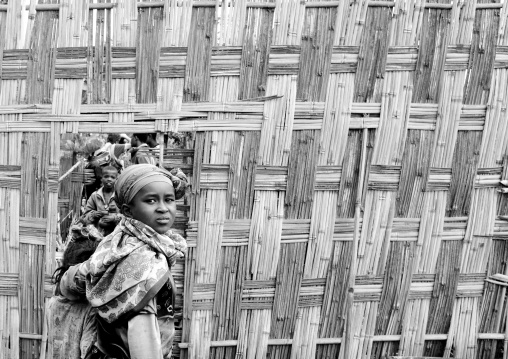 Dorze tribe kids seen through the door of a traditionally bamboo fence, Chencha, Omo valley, Ethiopia