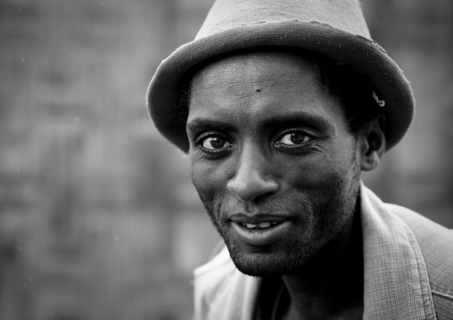 Black and white portrait of a young dorze tribe man with hat, Chencha, Ethiopia