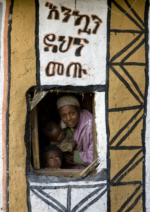 Mother and children in a decorated tukul, Hosanna, Ethiopia