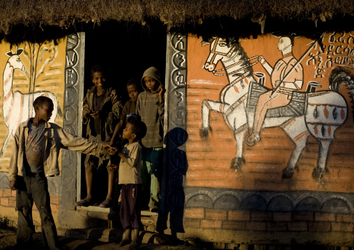 Kids in front of a typically painted hosanna house, Ethiopia