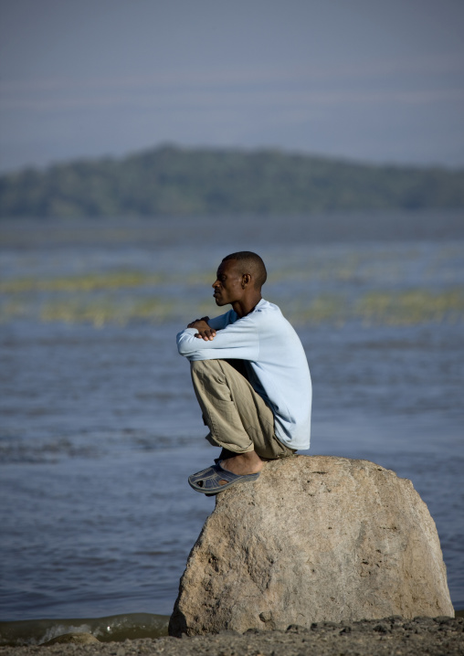 Oromo Man Sitting Alone On A Rock, Chamo Lake, Ethiopia