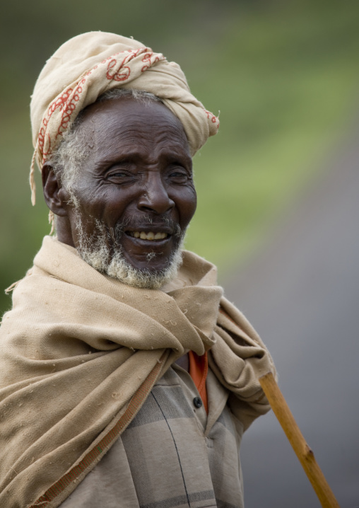 Portrait of an old man from gabrah tribe with toothy smile, Yabello, Omo valley, Ethiopia