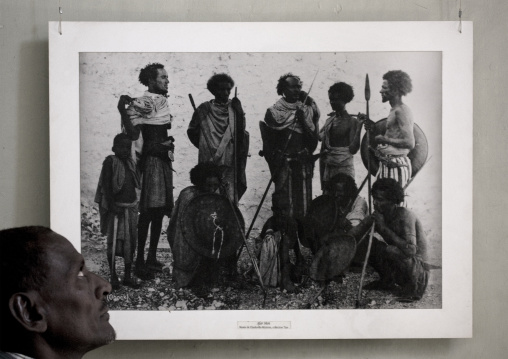Afar Man Watching An Old Picture Of His Ancestors, Harar, Ethiopia