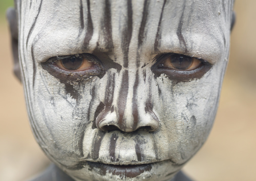 Mursi Young Boy With White Painted Face And A Serious Look, Omo Valley, Ethiopia