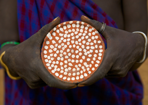 Mursi Tribe Woman Holding A Clay Lip Plate With White Dots, Omo Valley, Southern Ethiopia