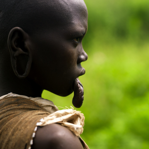 Portrait Of A Young Mursi Tribe Woman With Enlarged Lip In Mago National Park, Omo Valley, Ethiopia