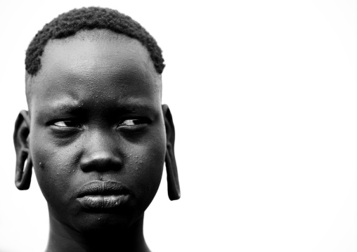 Black And White Portrait Of A Young Surma Tribe Woman With Enlarged Ears, Tulgit, Omo Valley, Ethiopia