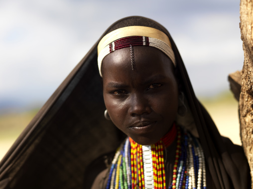 Portrait Of Arbore Tribe Teenage Girl Veiled With Necklaces, Omo Valley, Ethiopia