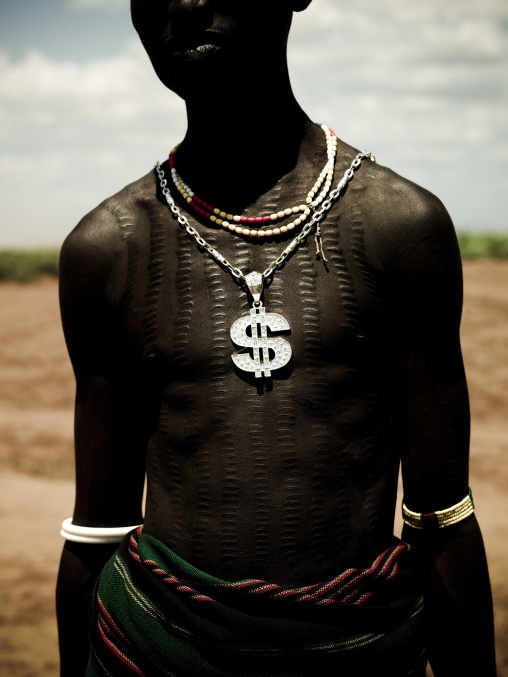 Dollar Sign Pendant On A Dassanech Tribe Teenage Boy With Scarified Chest, Omo Valley, Ethiopia