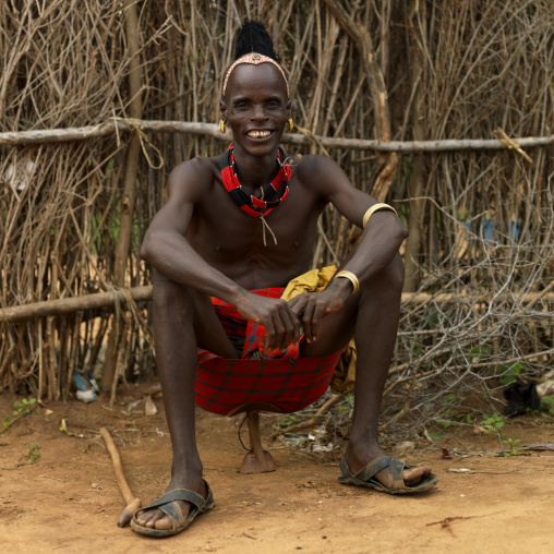 Portrait Of Smiling Hamar Tribe Man Sitting On Headrest In Turmi, Omo Valley, Ethiopia