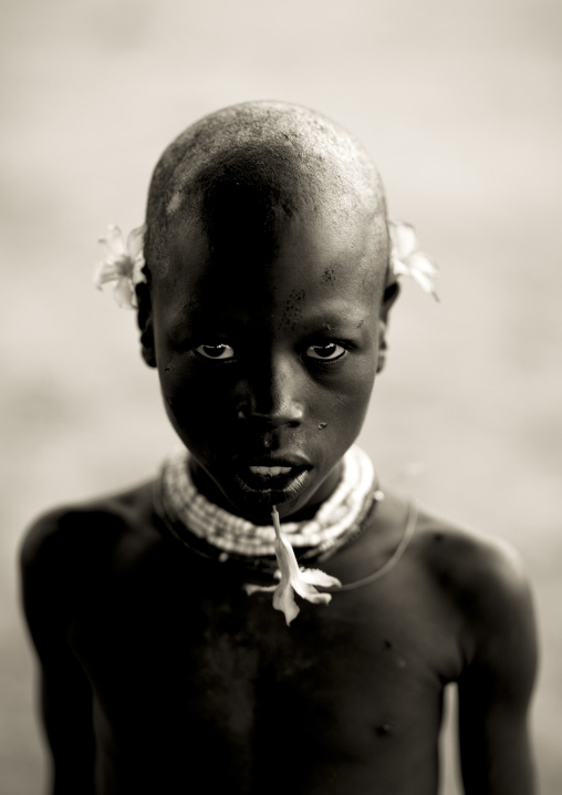 Portrait Of A Karo Tribe Kid With Flowers As Earrings, Korcho Village, Omo Valley, Ethiopia