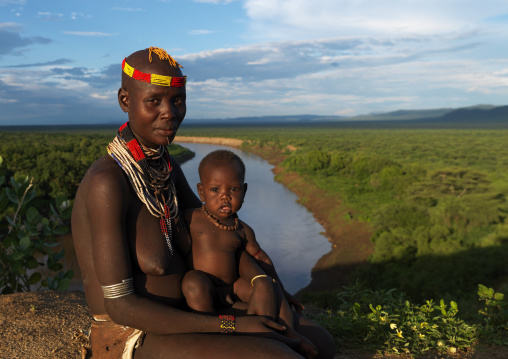Portrait Of A Karo Tribe Mother And Kid Over The Omo River At Sunset, Korcho Village, Omo Valley, Ethiopia