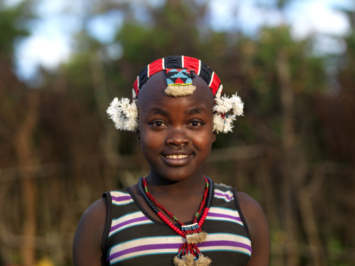 Portrait Of Cute Bashada Teenage Girl Wearing Traditional Headdress And Necklace Omo Valley Ethiopia
