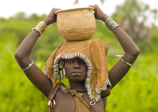 Mursi Tribe Girl Carrying A Wickerwork Container On Her Head, Omo Valley, Ethiopia