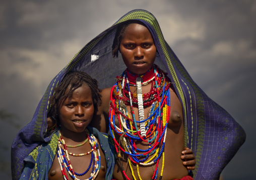 Young Erbore Girls With Beaded Necklaces Posing Under Large Canvas Ethiopia