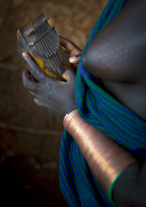 Suri tribe woman holding a kalimba, Kibish, Omo valley, Ethiopia