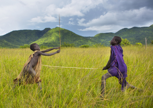Children making a donga stick fighting in Suri tribe, Tulgit, Omo valley, Ethiopia