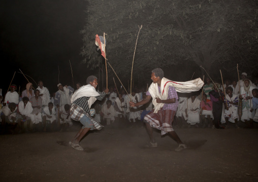 Night Shot Of Two Karrayyu Tribe Men During A Choreographed Stick Fighting Dance At Gadaaa Ceremony, Metahara, Ethiopia
