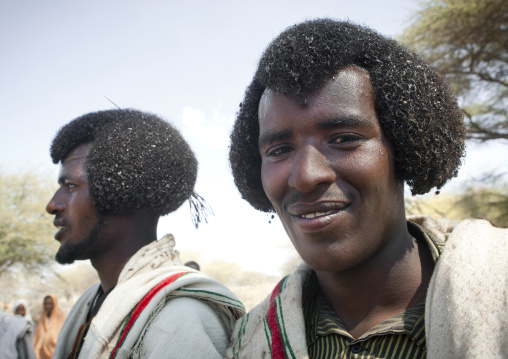 Two Young And Smiling Karrayyu Men With Traditional Gunfura Hairstyle In Gadaaa Ceremony, Metehara, Ethiopia
