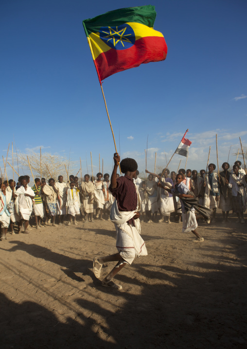 Karrayyu Tribe Man Carrying The Ethiopian Flag During Stick Fighting Dance, Gadaaa Ceremony, Metahara, Ethiopia