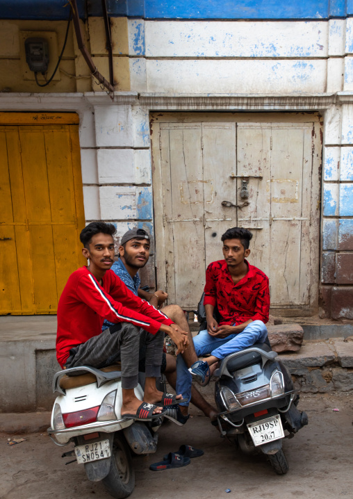Indian young men with scooters in the street, Rajasthan, Jodhpur, India