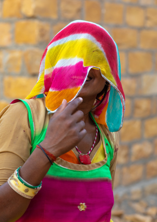 Portrait of a rajasthani woman hidding her face under a sari, Rajasthan, Jaisalmer, India