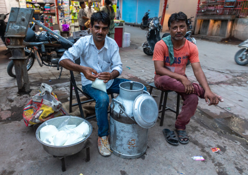 Indian men selling fresh milk in the street, Rajasthan, Jodhpur, India