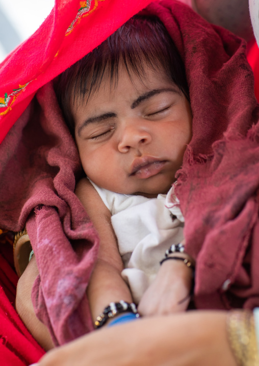 Indian baby sleeping with make up on eyebrows, Rajasthan, Baswa, India