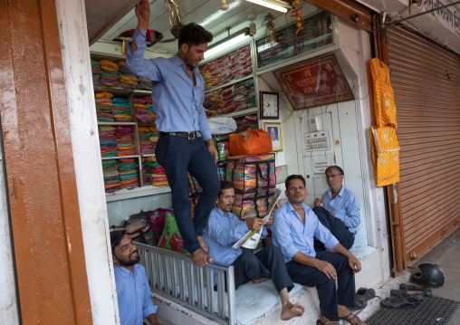 Indian sellers waiting in a textiles shop, Rajasthan, Jaipur, India