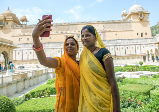 Indian women taking selfie in front of Amer fort and palace, Rajasthan, Amer, India