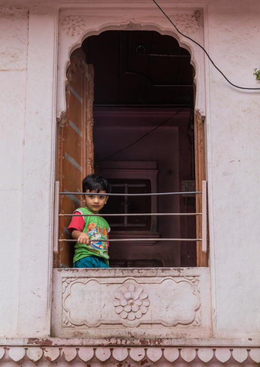 Portrait of a rajasthani boy in a window, Rajasthan, Bikaner, India
