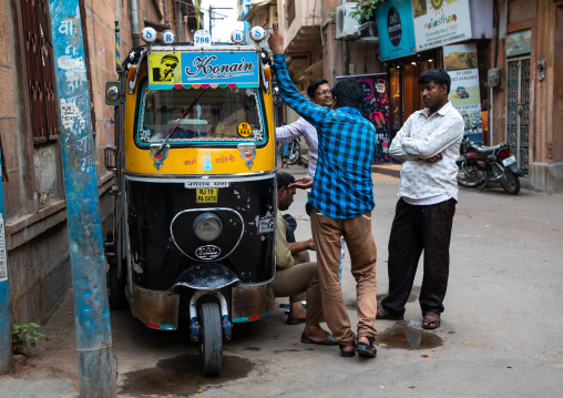 Indian men chatting near a rickshaw parked in city, Rajasthan, Jodhpur, India