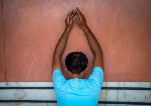 Indian man praying in a temple, Rajasthan, Jaipur, India