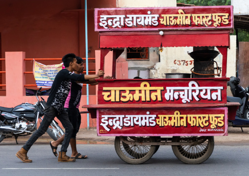 Indian men pushing a food stall, Rajasthan, Bikaner, India