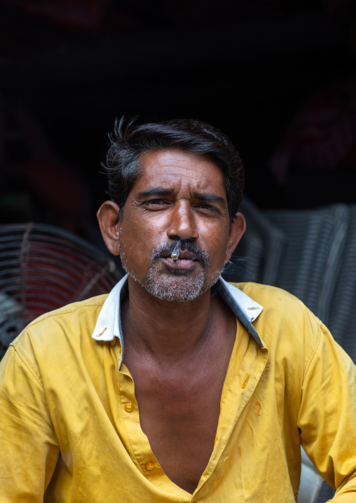 Portrait of an indian man smoking a cigarette in the street, Rajasthan, Bundi, India