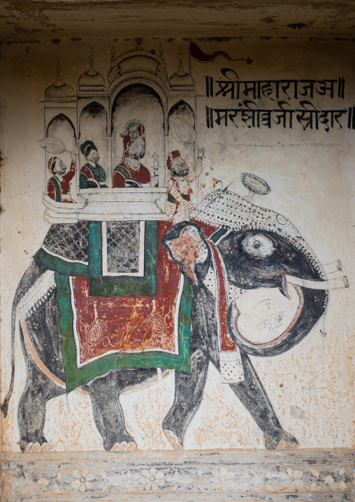 Wall paintings depicting indian people riding an elephant on an old haveli, Rajasthan, Nawalgarh, India