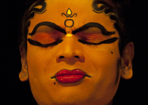 Close Up Of A Kathakali Dancer With Traditional Face Make Up Eyes Closed, Kochi, India