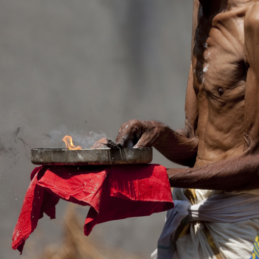 Priest Holding Flames And Ashes In A Plate During Theyyam Ceremony, Thalassery, India