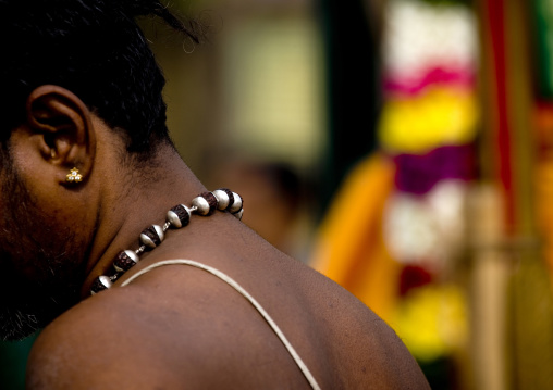 Priest From Behind Wearing A Necklace During Masi Magam Festival In Pondicherry, India