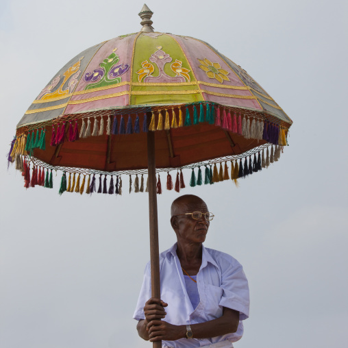 Man Holding A Colorful Umbrella At Masi Magam Festival, Pondicherry, India
