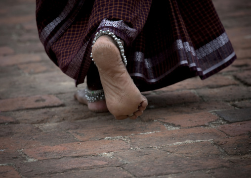 Calloused Feet Of A Woman With Ankle Bangles Walking On Thanjavur's Street, India
