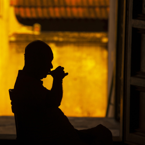 Man Sitting On A Chair Drinking In The Darkness Of His House, Kanadukathan Chettinad, India