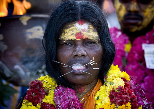 Woman With Peaks In Her Tongue, Traditional Painting On Her Forehead And A Flower Garland During A Fire Walking Ceremony, Madurai, South India