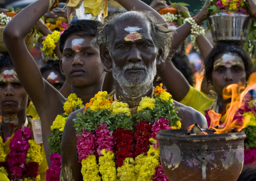People With Traditional Painting On The Forehaed And Flower Garland Holding Offerings And Jar On Fire During A Fire Walking Ceremony, Madurai, South India