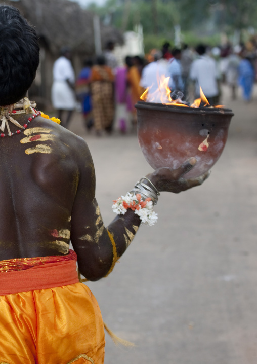 Rear View Of A Man With Painting On His Body Holding A Jar On Fire In One Hand Fire Walking Ritual, Madurai, South India