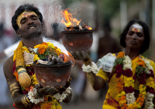 Indian Man And Woman With Traditional Painting On The Forehead In Procession Holding Jar On Fire As Offering During Fire Walking Ritual, Madurai, South India