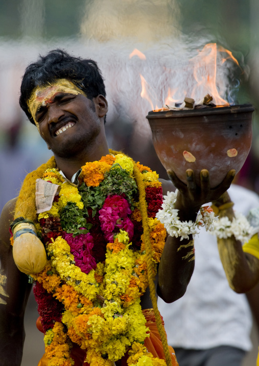 Suffering Man With Traditional Painting On His Forehead Holding A Jar On Fire During Fire Walking Ritual, Madurai, South India