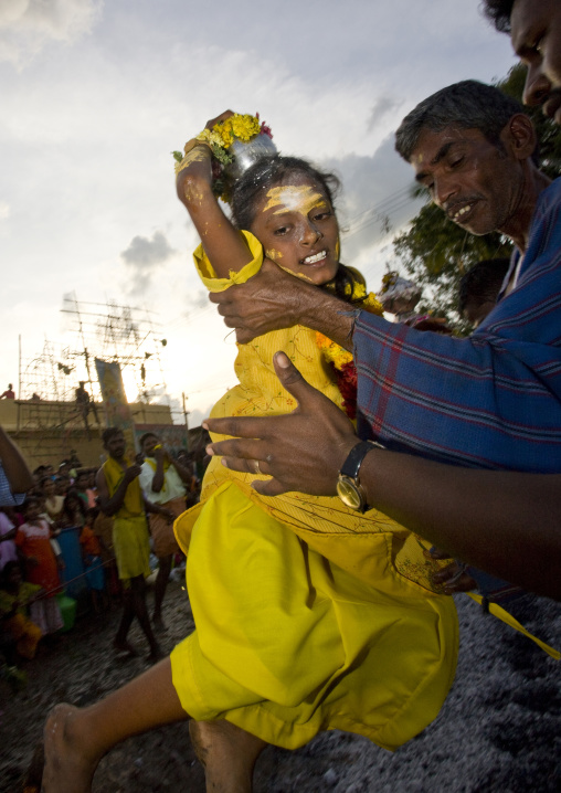 Little Girl With Yellow Clothes Carried By A Man Succeeding At Fire Walking In Tamil Nadu, Madurai, South India